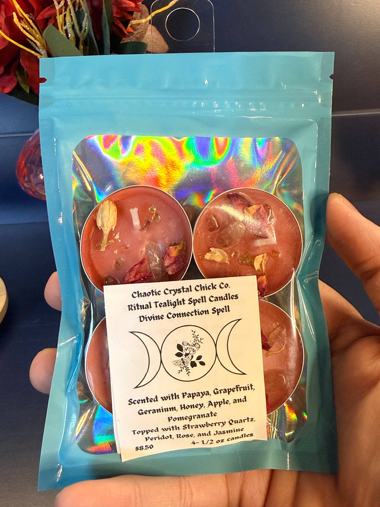A pack of four orange tealights sitting against a blue background