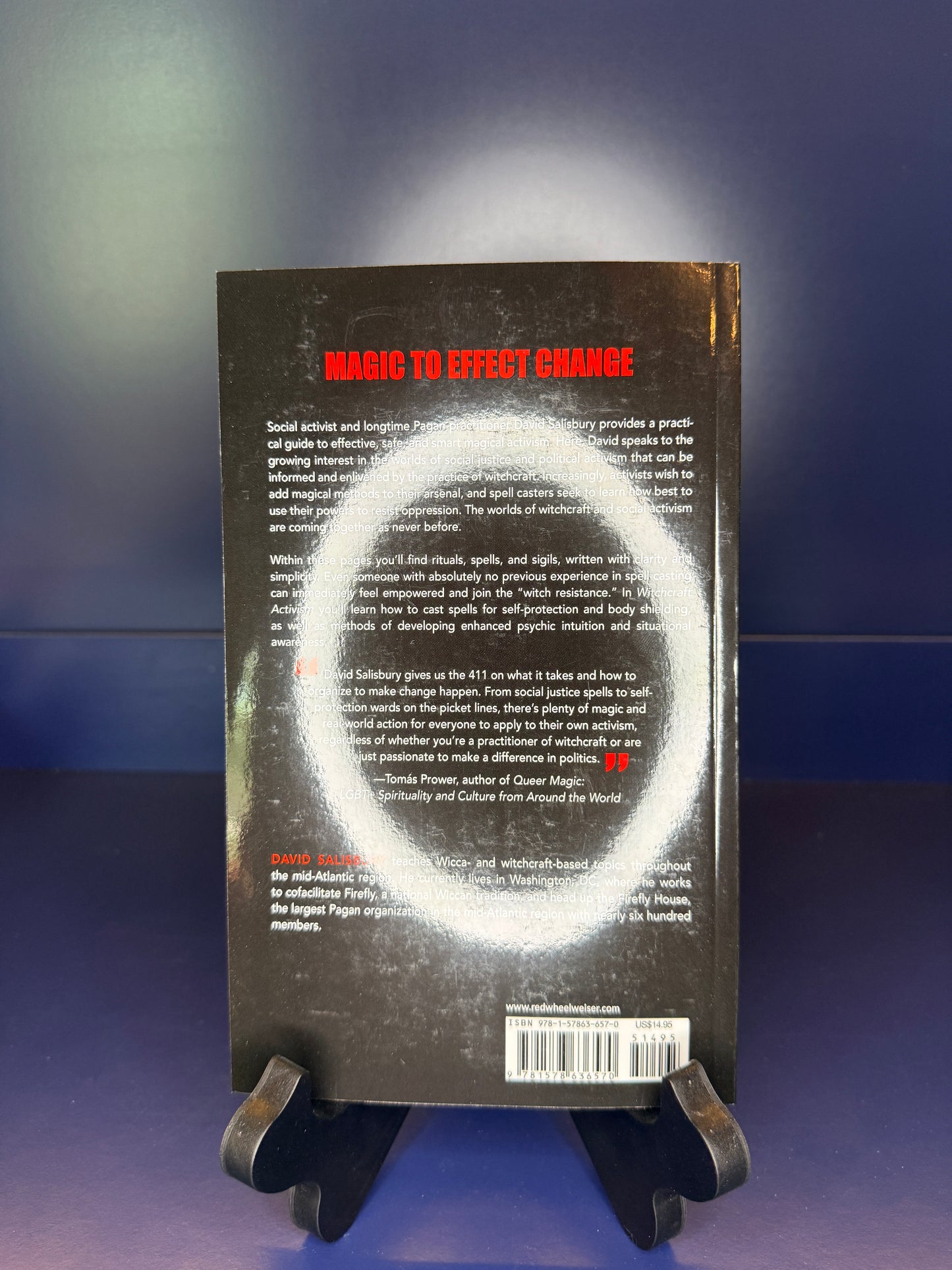 Book with heading 'Magic to Effect Change' on a stand with a blue gradient background