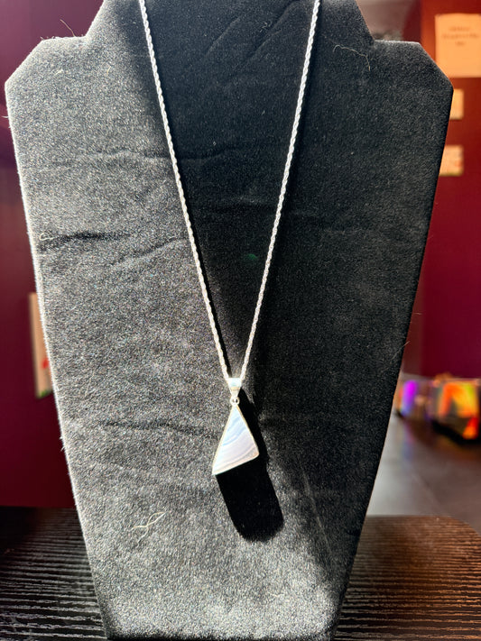 Sterling Silver Necklace resting on a black velvet jewelry stand holding a blue lace agate pendant