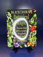 Book titled 'Blackthorn's Botanical Magic' on a stand with a dark background