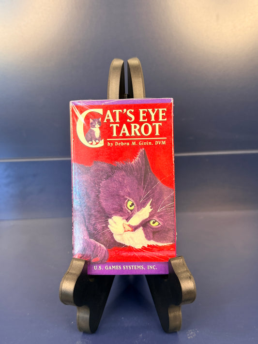 Cat's Eye Tarot on a black stand against a blue background