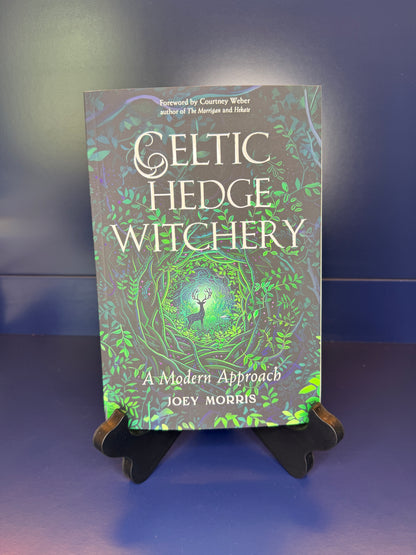 Book titled 'Celtic Hedge Witchery' by Joey Morris on a stand against a blue background