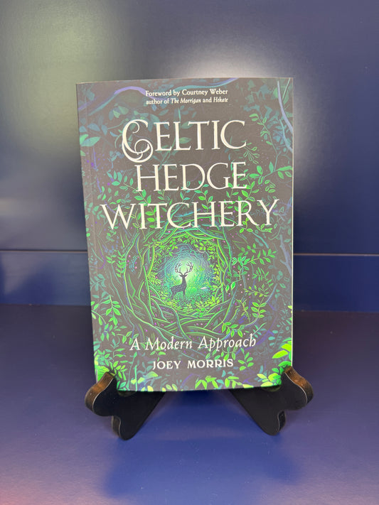 Book titled 'Celtic Hedge Witchery' by Joey Morris on a stand against a blue background