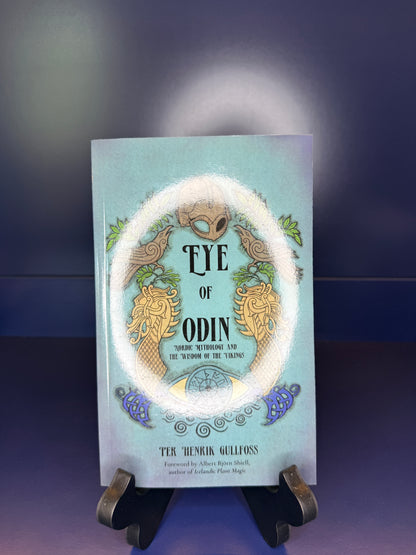 Book titled 'Eye of Odin' on a stand with a dark background