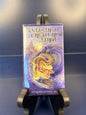 Fantastical Creatures Tarot on a black stand against a blue background