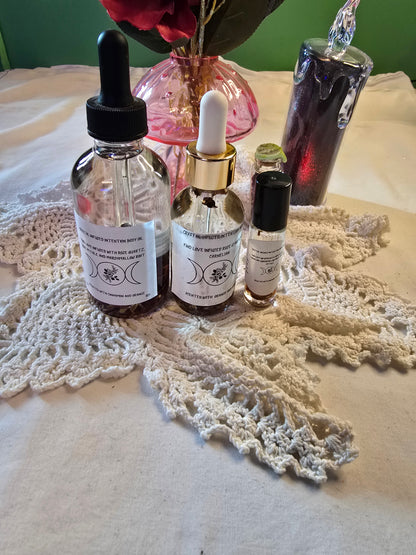 Three glass bottles filled with clear body oil with herbs on a white crochet mat and white table cloth