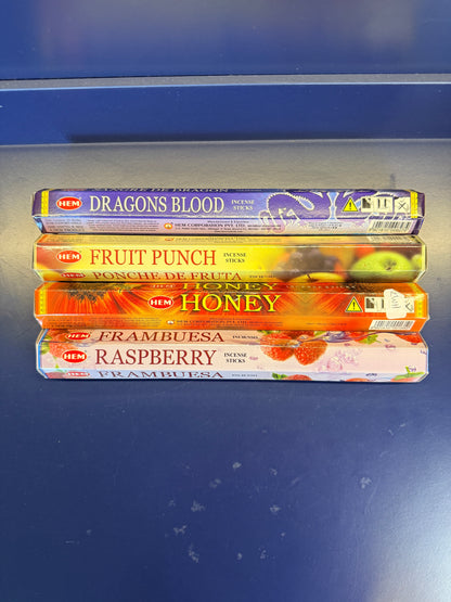 Four colorful incense boxes on a blue background