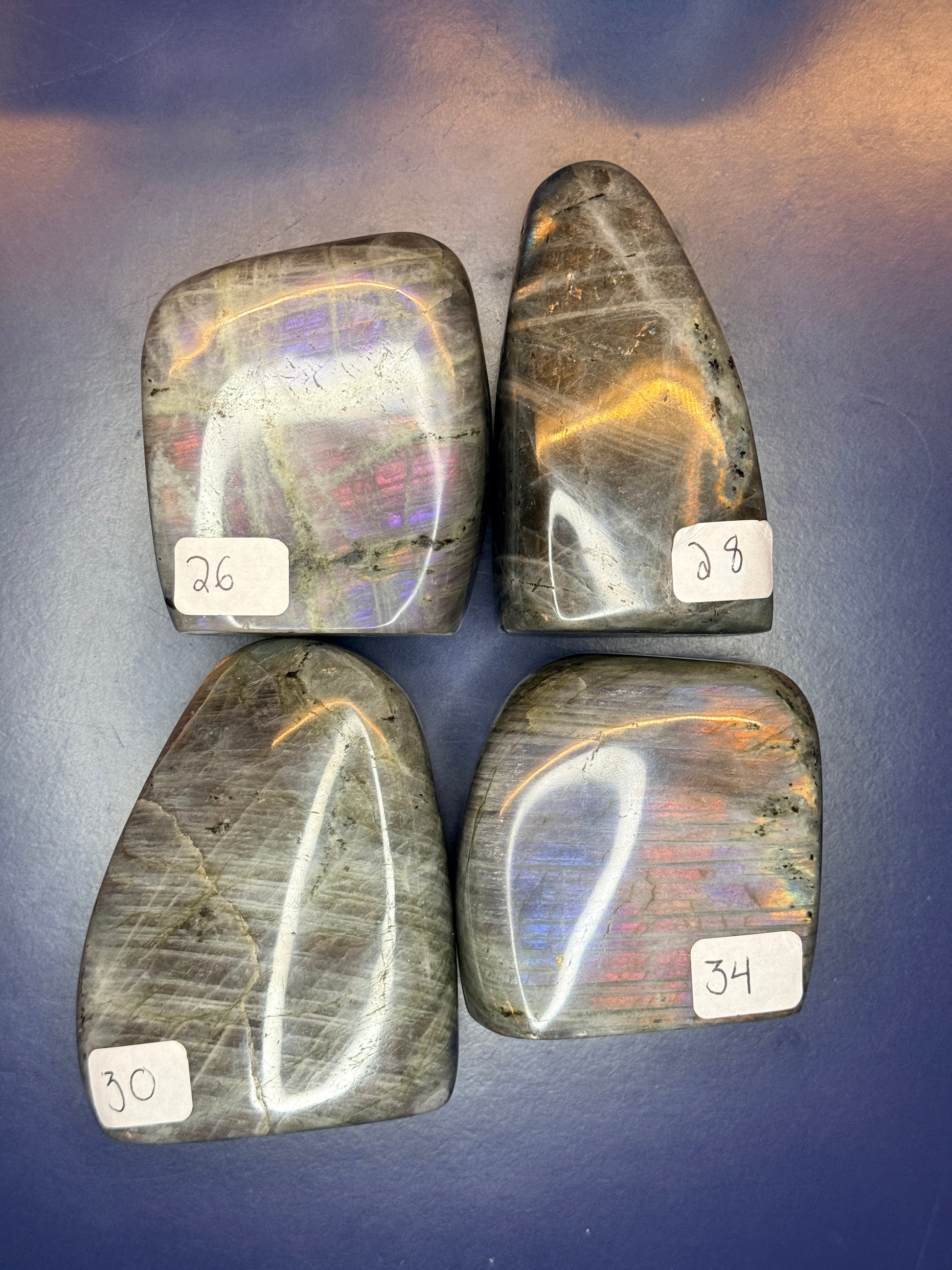 Six grey labradorite free forms with purple flash and numbered labels on a blue background