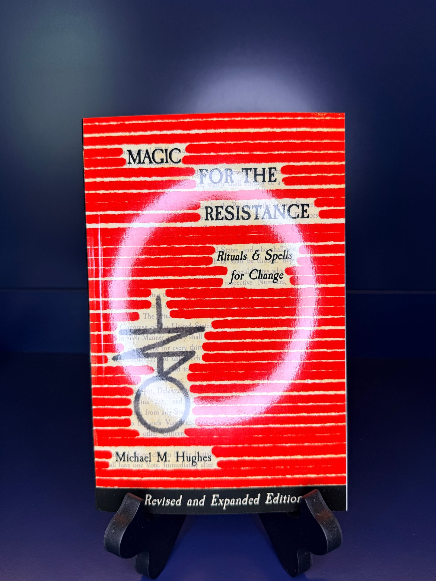 Red book titled 'Magic for the Resistance' on a dark blue background
