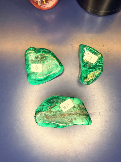 Three green marbled malachite free forms with numbered labels on a blue background