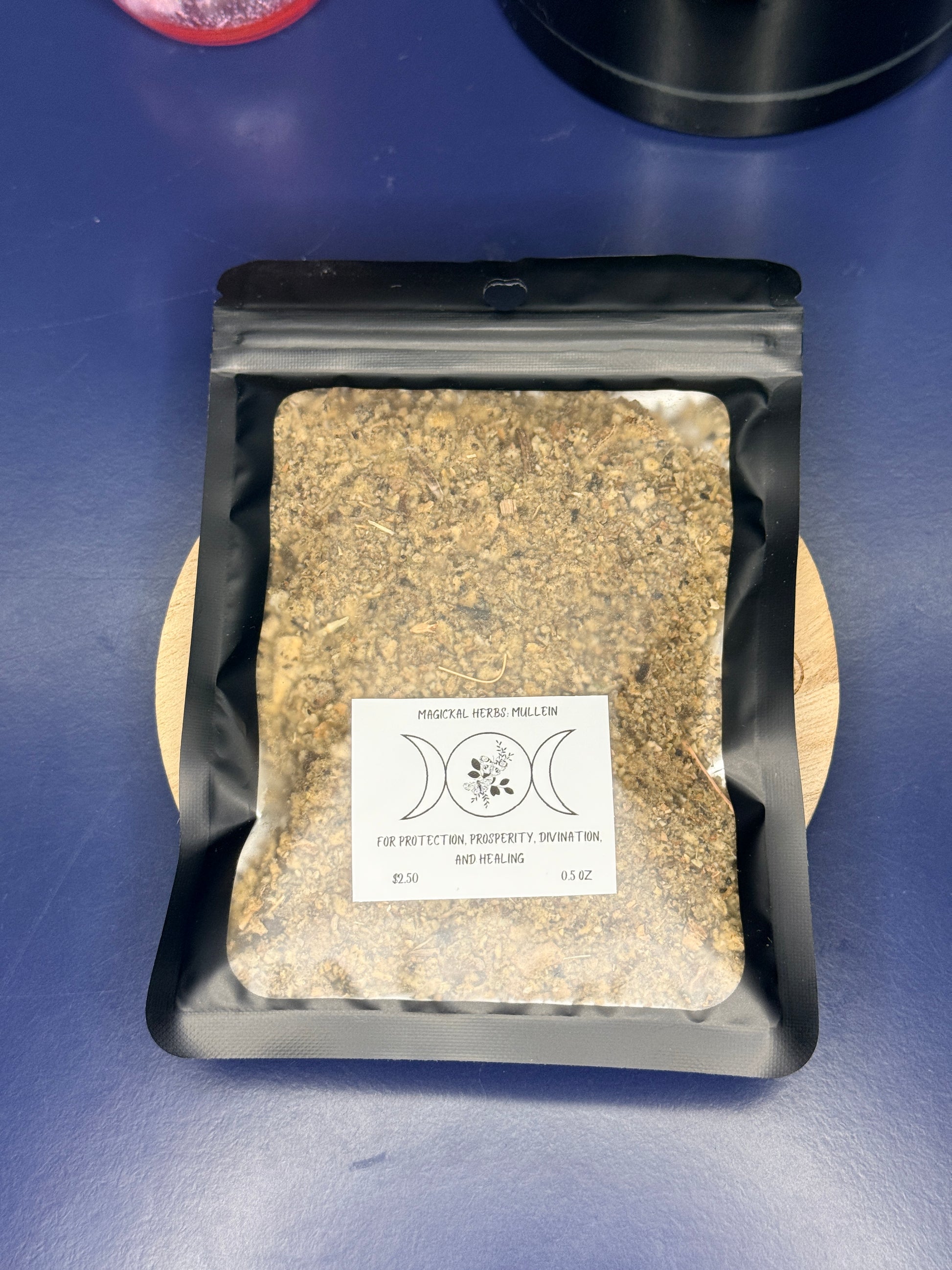 Black package of mullein herbs with a white label on a blue background