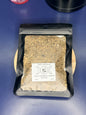 Black package of mullein herbs with a white label on a blue background