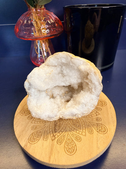 Crystal geode on a wooden coaster with decorative elements