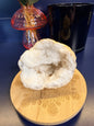 Crystal geode on a wooden coaster with decorative elements