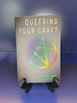 Book titled 'Queering Your Craft' with a colorful circle design on a blue background
