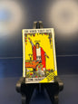Rider Tarot Deck packaging on a black stand against a dark background