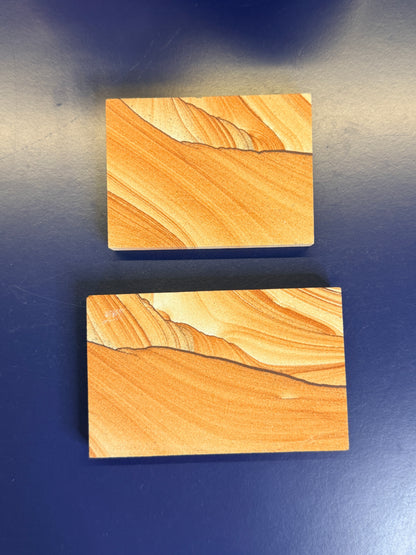 Two orange textured sandstone rectangular slabs on a blue background