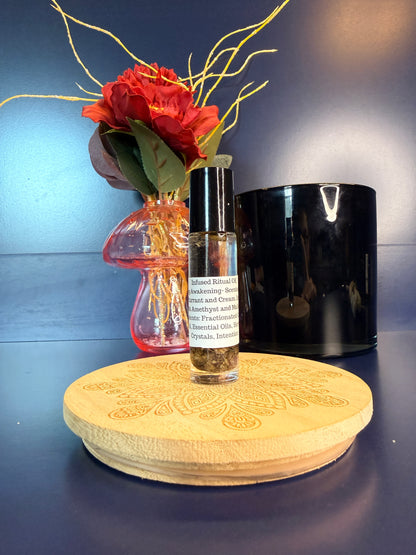Body Oil Vial sitting on a decorative wooden coaster in front of a red flower and black jar
