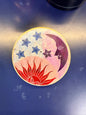 Round incense burner with a sun, star, and moon design on a blue background