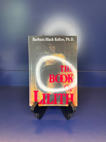 Book titled 'The Book of Lilith' by Barbara Black Koltuv, Ph.D. on a stand against a blue background
