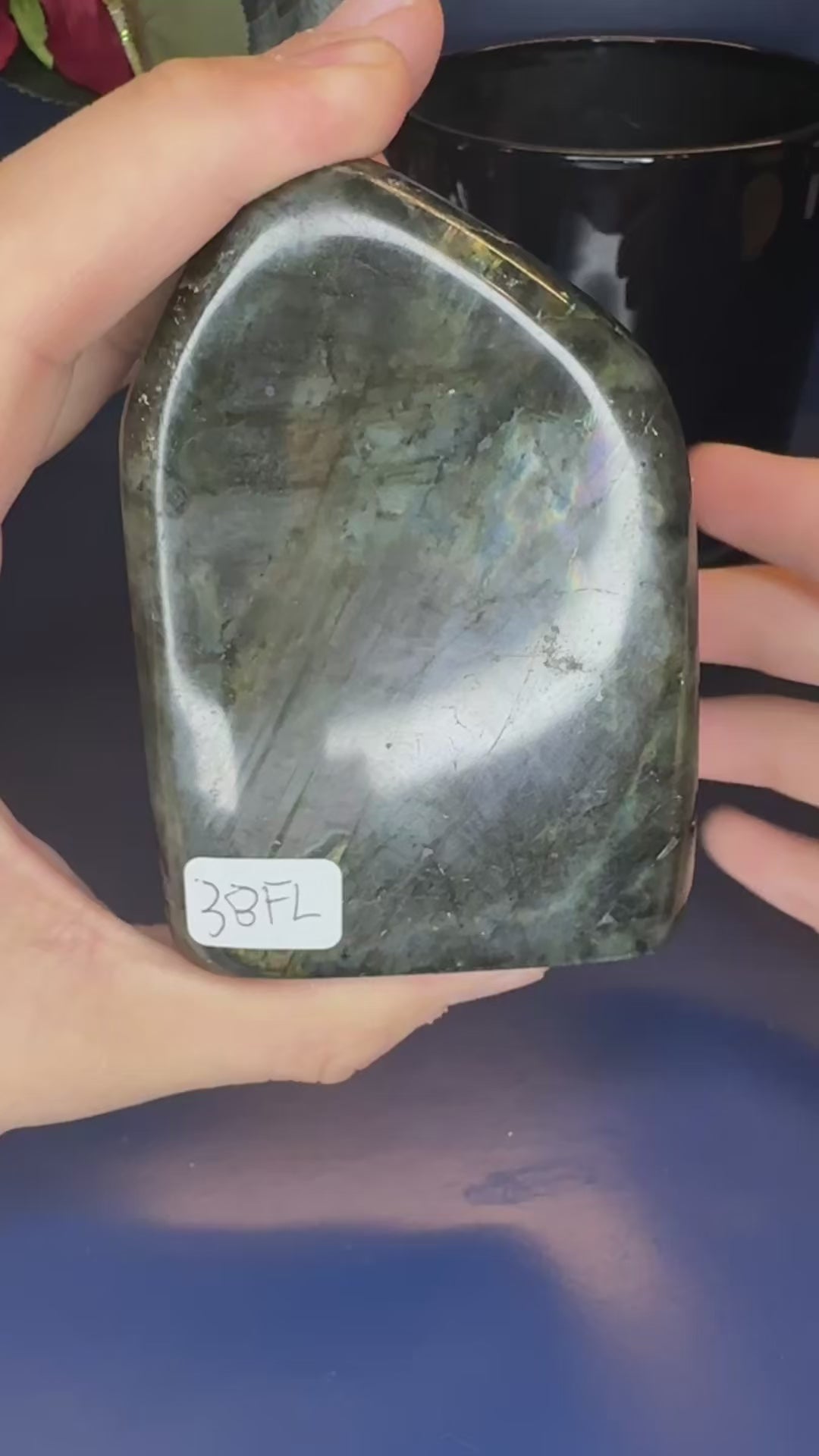 Two hands showing the purple sunset flash on large labradorite free forms